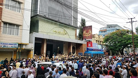 Investors protest outside IMA Jewels showroom in Bengaluru on 10 June 2019, after an audio clip by its absconding owner went viral. (Photo | EPS)