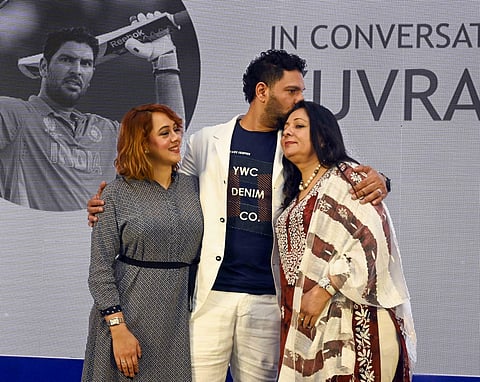 Cricketer Yuvraj Singh kisses on the head of his mother Shabnam as his wife Hazel Keech looks on. (Photo | PTI)