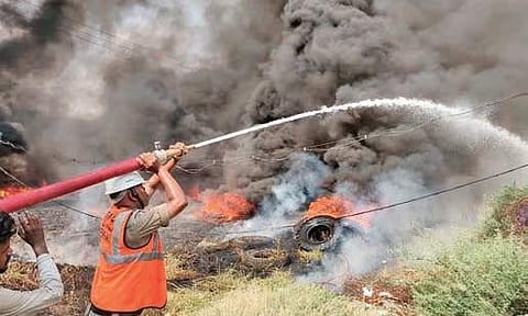 Firefighters use a water cannon to douse fire at a scrap yard in Auto Nagar in the city on Sunday. (Photo | EPS)