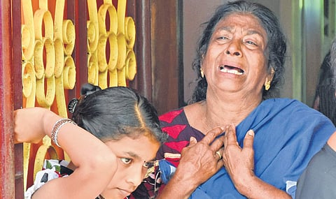Subhadra, wife of Radhakrishnan who got electrocuted at Pulli lane near Pettah in Thiruvananthapuram on Monday, breaks down at her residence B P Deepu