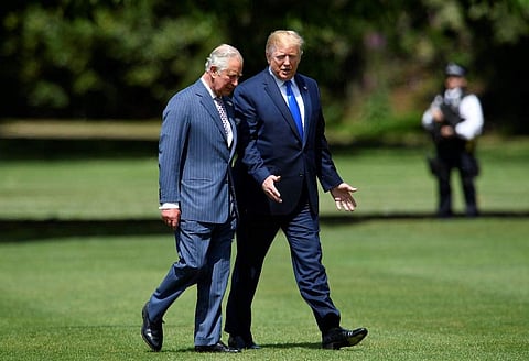 US President Donald Trump (R) walks with Britain's Prince Charles, Prince of Wales (L) as he arrives for a welcome ceremony at Buckingham Palace in central London. (Photo | AFP)