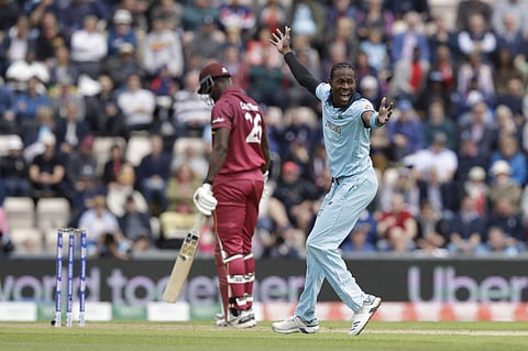 England's Jofra Archer, right, celebrates taking the wicket of West Indies' Carlos Brathwaite, left, during the Cricket World Cup match between England and West Indies at the Hampshire Bowl in Southampton. (Photo | AP)