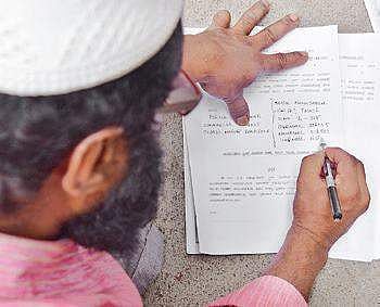 A victim writing a complaint against IMA on Thursday | vinod kumar t