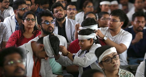 Members of Resident Doctors Association RDA of AIIMS wearing bandages on their heads protest to show solidarity with their counterparts in West Bengal who stopped work on Tuesday protesting against the assault on their colleagues in New Delhi on Friday Ju