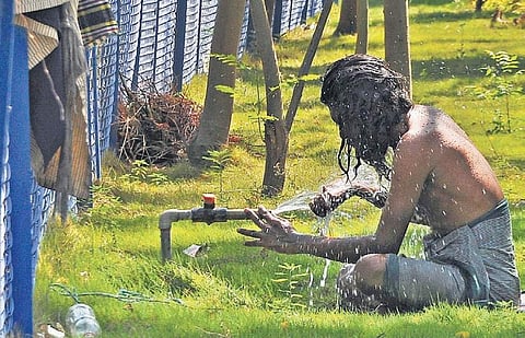 A man takes shower at a tap to beat the heat in Vijayawada on Saturday. (Photo I Prasant Madugula/EPS)