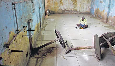 (Top) A man having lunch inside an Amma Unavagam on Demellows Road in Chennai;