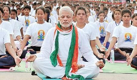 A file photo of PM Narendra Modi performing yoga at Rajpath in  New Delhi.