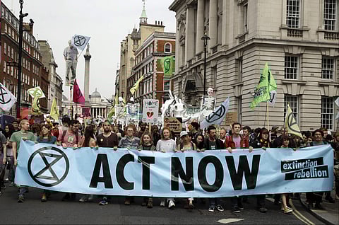 In this Tuesday April 23, 2019 file photo, climate change protesters march along Whitehall toward parliament, in London. Britain's prime minister has announced plans to eliminate the country's net contribution to climate change by 2050. (Photo | AP)