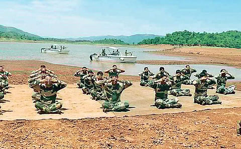 BSF personnel performing yoga on the premises of a Company Operating Base (COB) at Janbai in Swabhiman Anchal on Sunday. (Photo | EPS)