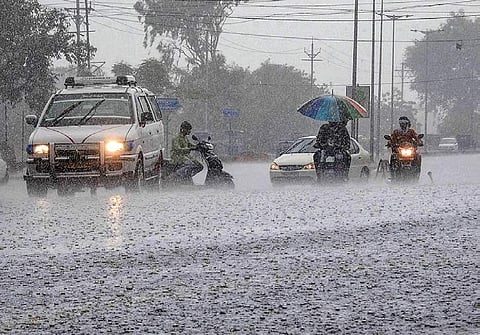Commuters ride their vehicles during heavy pre-monsoon rains in Bhopal | PTI