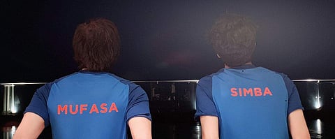 Shah Rukh took to Twitter to share a photograph of him and his son sporting blue cricket jerseys with 'Mufasa' and 'Simba' printed on it. (Photo | @iamsrk/twitter)