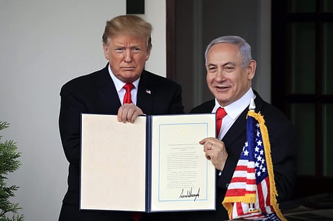 US President Donald Trump and Israeli PM Benjamin Netanyahu hold up the signed proclamation recognising Israeli sovereignty over Golan Heights. (File Photo | PTI)