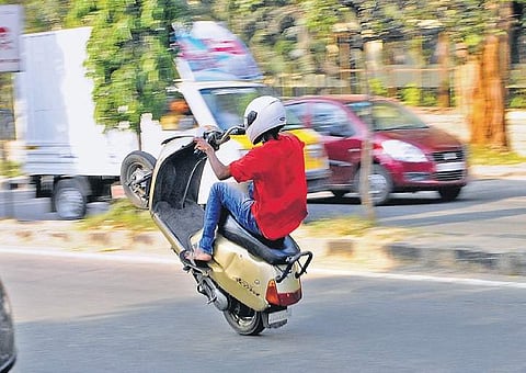 A bike rider wheeling on the busy Ring Road at Hoskere Halli in the city. (Photo | EPS)