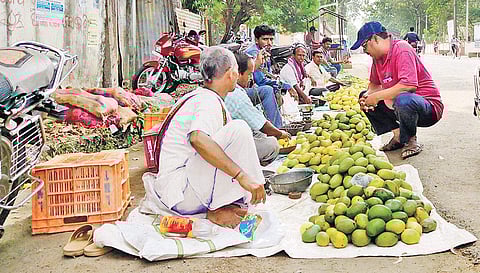 Mango farmers spread out their meagre produce for sale in Jeypore town. ( Photo | EPS)