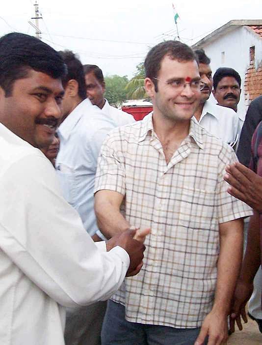 Congress MP Rahul Gandhi shaking hands with villagers after interacting with self help groups of an NGO at Banda Somaram village district in Andhra Pradesh. (Express Photo)