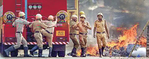 Firefighters douse a blaze during clashes between the BJP and TMC activists in West Bengal (File Photo | PTI)