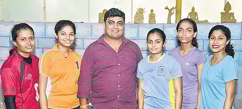 C Sandeep S Rao (centre) flanked by the women wrestlers he trains at a college in Dakshina Kannada district | Rajesh Shetty Ballalbagh