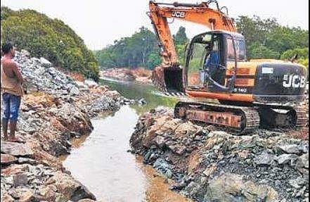 Earthmovers dig small canals in the Gangavali river to bring water from pits to the pump house at Honnalli | EXPRESS