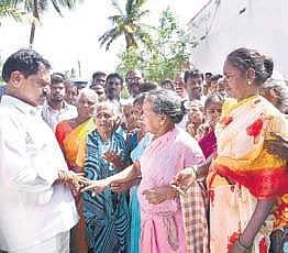 Deputy CM and Minister for Excise and Commercial Taxes with residents of Padari Kuppam.