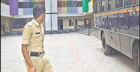 Police stand outside the Government VK Obaidullah School