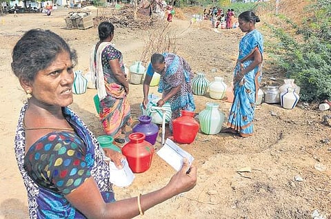 A woman showing a lot given to her to get water, at Karunkulam village  in Ramanathapuram district | ponmalar