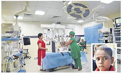 Staff test a newly installed robotic surgery unit at KMIO, in Bengaluru on Thursday; (inset) The nine-year-old boy who was treated | NAGARAJA GADEKAl