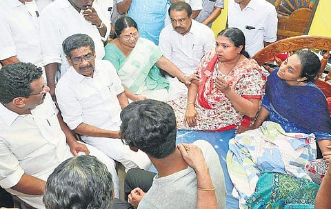 KPCC president Mullappally Ramachandran and DCC president Satheeshan Pacheni at the house of Sajan Parayil to console his wife E P Beena