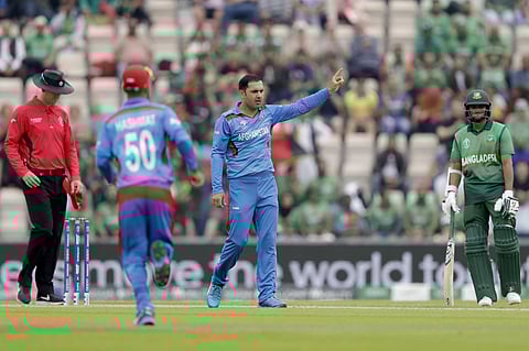 Afghanistan's Mohammad Nabi celebrates taking the wicket of Bangladesh's Tamim Iqbal. (Photo | AP)