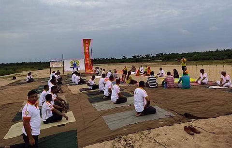 ndhra Pradesh Members of Amravati Walkers and Runners Association AWARA and NDRF 10th Battalion crew participating in the Yoga Week in the Nature on the Krishna River bed on Sunday | Express