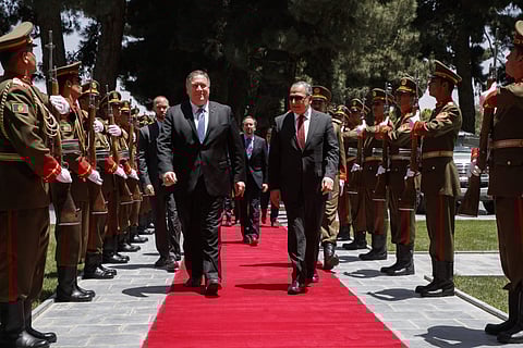 Secretary of State Mike Pompeo, center left, walks with Afghan President Ashraf Ghani's Chief of Staff Abdul Salam Rahimi, as he arrives at the Presidential Palace in Kabul, Afghanistan, Tuesday, June 25, 2019, during an unannounced visit. (Photo | AP)