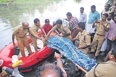 Navy and Fire and Rescue Service personnel taking out the body of Jennis who went missing in the backwater near Elamkulam on Sunday night after a day-long search on Monday |  A Sanesh