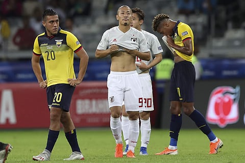 Japan's Daizen Maeda, center, Ecuador's Andres Chicaiza, left, and Ecuador's Ayrton Preciado, right, stand on the field at the end of their Copa America Group C soccer match at the Mineirao stadium in Belo Horizonte, Brazil. (Photo | AP)