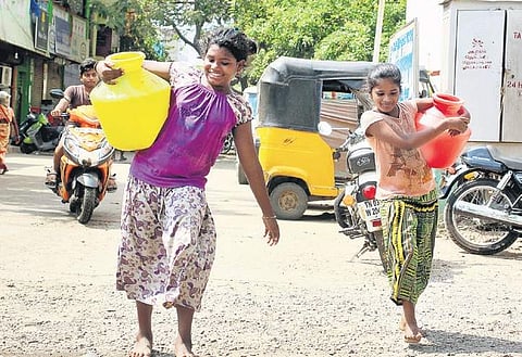 Darshini J (9) and Priya S (11) skip classes on alternate days to fetch water.  (Photo | Debadatta Mallick, EPS)