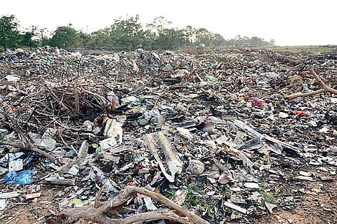 Construction debris and garbage dumped on Mahanadi bed. ( Photo | EPS)