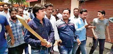 In this video grab, BJP MLA Akash Vijayvargiya is seen raising a cricket bat to assault a municipal official in Indore on Wednesday | PTI