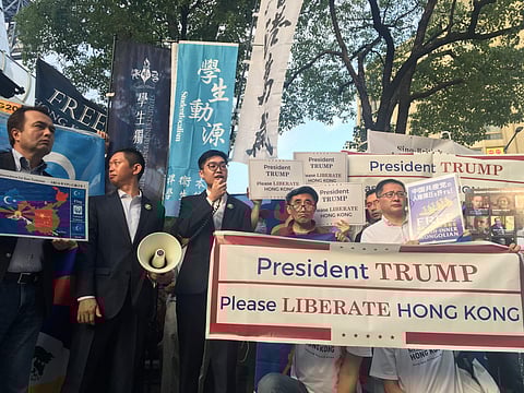 Uyghur protesters wear chains during an anti-China rally in Osaka, Japan on Friday, June 28, 2019. (Photo | AP)