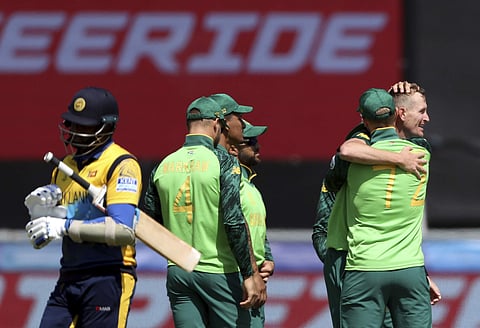 South Africa's bowler Chris Morris, far right, celebrates with teammates after bowling Sri Lanka's batsman Angelo Mathews, far left, for 30 runs during the Cricket World Cup match between Sri Lanka and South Africa. (Photo | AP)