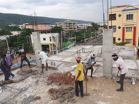 An illegal construction being removed by demolition squad in Visakhapatnam on Friday.  (Photo | EPS)