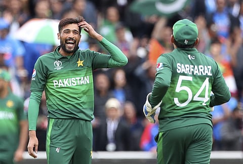 Mohammad Amir with skipper Sarfaraz Ahmed. (Photo | AP)