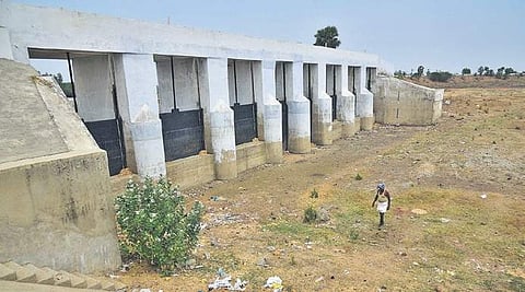 A farmer walks along the dry Nemam lakebed | P Jawahar