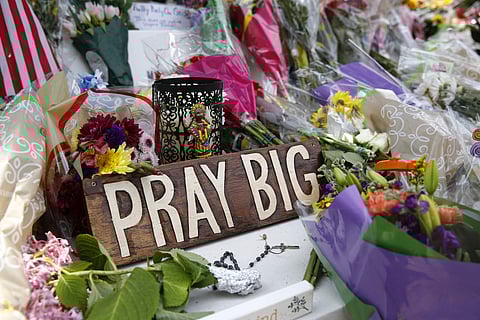 A sign sits among flowers and mementos left at a makeshift memorial for victims of a mass shooting at a municipal building in Virginia Beach, Va. (Photo | AP)