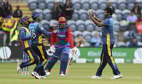 Sri Lanka's Thisara Perera is congratulated by his team mates after taking the wicket of Afghanistan's Mohammad Nabi. (Photo | AP)