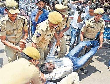 Police forcibly remove BJYM activists who staged a protest against the alleged Inter goof-up, in front of TSBIE office in Hyderabd on Tuesday | R V K Rao