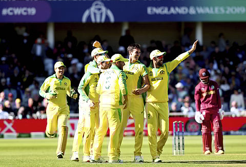 Australia's Pat Cummins celebrates with teammates the dismissal of West Indies' Shai Hope during the Cricket World Cup match between Australia and West Indies at Trent Bridge in Nottingham on 6 June 2019. (Photo | PTI)