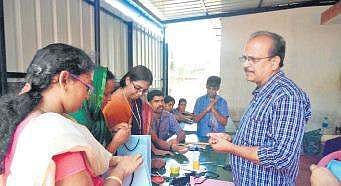 Sivamani giving training to make paper pens