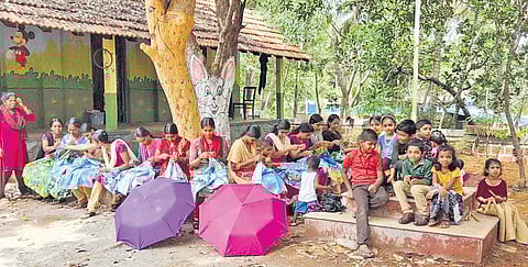 Mothers making umbrellas for the students of Government Lower Primary School, Cheriyakkara, in Kayyur-Cheemeni grama panchayat | Express