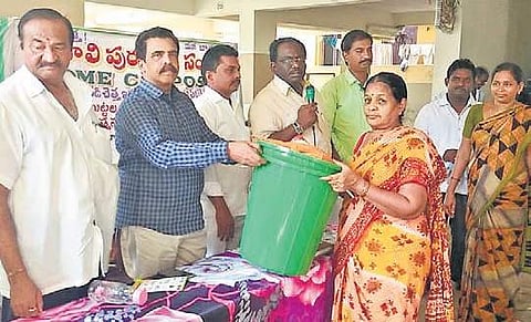 Municipal officials distributing bins to apartment residents in Tenali of Guntur district on Thursday | EXPRESS
