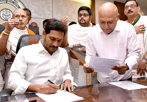 Andhra Pradesh CM YS Jagan Mohan Reddy signing a file after stepping into his chamber at Secretariat in Velagapudi on Saturday. (Photo | EPS)