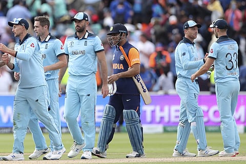 India's MS Dhoni, third right, watches as England players celebrate after their win in the Cricket World Cup match between England and India at Edgbaston in Birmingham. (Photo | AP)