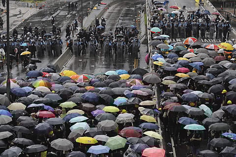 Protesters holding umbrellas face off police officers in anti-riot gear in Hong Kong on Monday, July 1, 2019. ( Photo | AP)